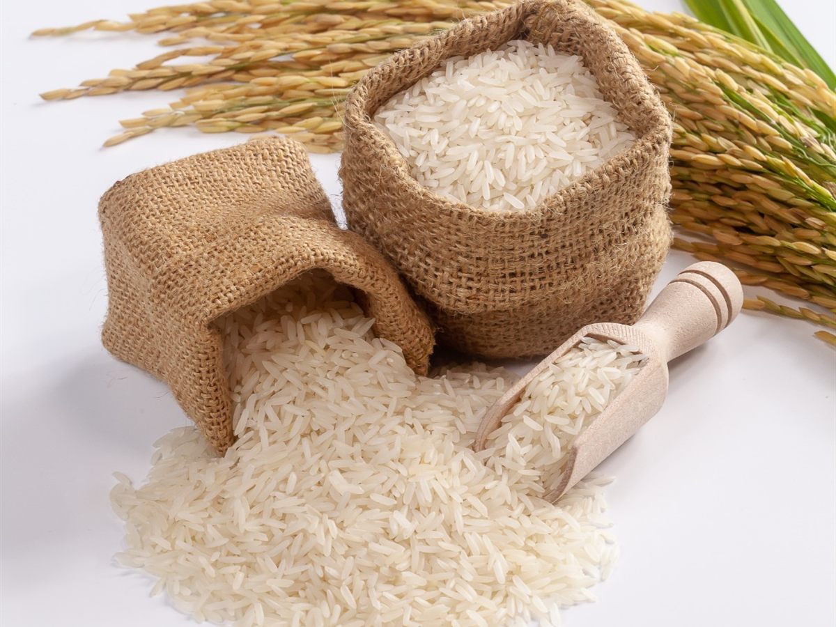 White rice in small jute bags with a wooden scoop